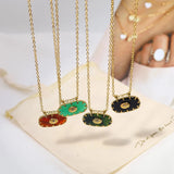 Luxurious emerald gemstone pendant on a gold chain necklace, displayed on a neck, highlighting intricate jewelry craftsmanship and natural materials.