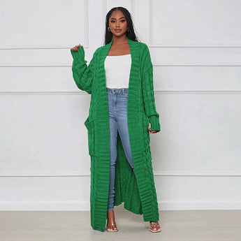 
A green oversized cozy cable knit cardigan for women, featuring a detailed knit pattern, long sleeves, and a relaxed fit.