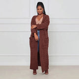 
A yellow cable knit cardigan for women, designed as an oversized cozy sweater. The garment features long sleeves and a wrap-style design, suitable for casual or semi-formal occasions.