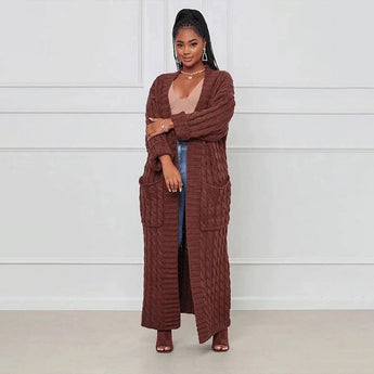 
A yellow cable knit cardigan for women, designed as an oversized cozy sweater. The garment features long sleeves and a wrap-style design, suitable for casual or semi-formal occasions.