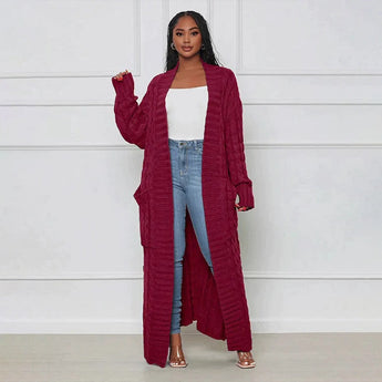 
Image of a woman wearing a burgundy oversized cable knit cardigan sweater, featuring a cozy design with long sleeves and an open front. The sweater has a loose fit, suitable for a comfortable and relaxed style.