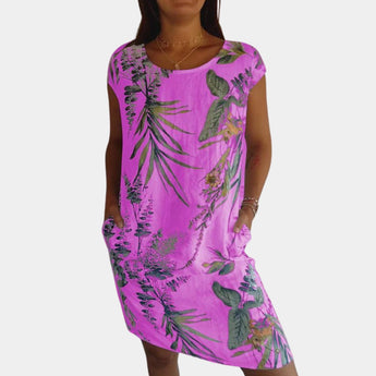 Purple floral tropical print women's summer dress with pockets, featuring short sleeves and a flattering waistline, shown in a 3XL size.