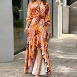 Orange floral V-neck wrap dress with a tropical print, high-low hemline, and long sleeves, modeled in a 3XL size, showcasing a trendy and elegant fashion design.