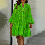 Bright green long sleeve eyelet dress in lightweight cotton, featuring a collared neckline, defined waist, and flowing sleeves, suitable for spring weather.