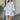 Yellow long sleeve eyelet dress made of lightweight cotton, featuring a knee-length design with a fitted waist and round neckline, suitable for spring.