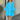 Yellow long sleeve eyelet dress in heavenly blue, featuring a lightweight cotton fabric, suitable for spring; model is wearing a size 3XL and smiling with hands on hips.