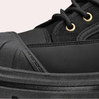 Youth urban black combat boots with neon stripe and contrast stitching, featuring a rugged design suitable for outdoor activities.