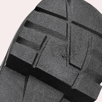 Youth urban black combat boots featuring neon stripes and contrast stitching, displayed on a textured road surface.