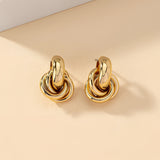 Gold Spiral Earrings featuring a modern, multi-loop design, showcasing luxury and intricate craftsmanship in designer jewelry.