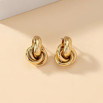 Gold Spiral Earrings featuring a modern, multi-loop design, showcasing luxury and intricate craftsmanship in designer jewelry.