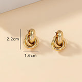 Gold Spiral Earrings featuring modern, luxury, multi-loop design in gold metal, resembling spirals and circles, high-end designer jewelry.